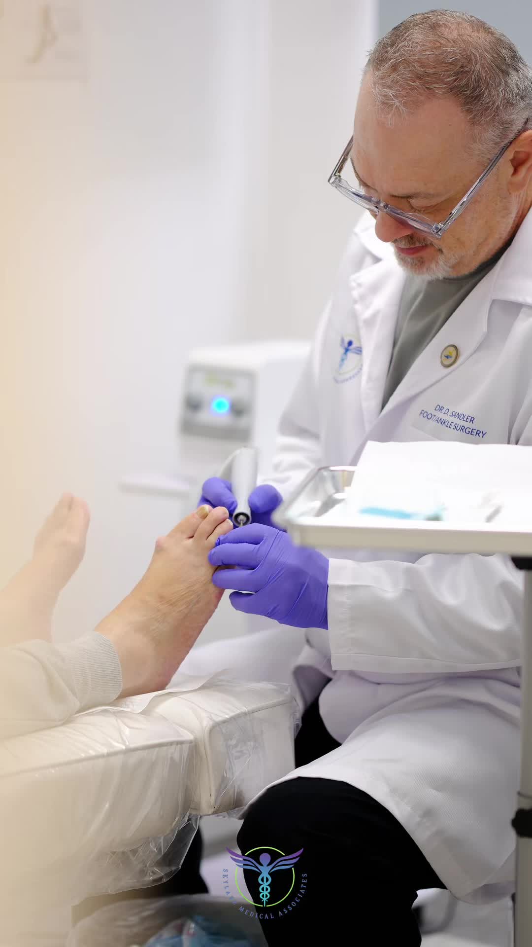 Dr. Dmitry Sandler, DPM, FACFAS, treating a patient at Skylake Medical Associates
